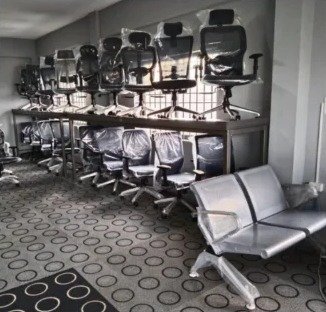 Chair factory: chairs lined up beside a steel bench