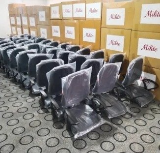 Chair factory: finished chairs lined up next to packed cartons
